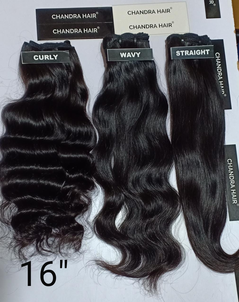 Raw South Indian hair bundles labelled 16 inches, length chart photo
