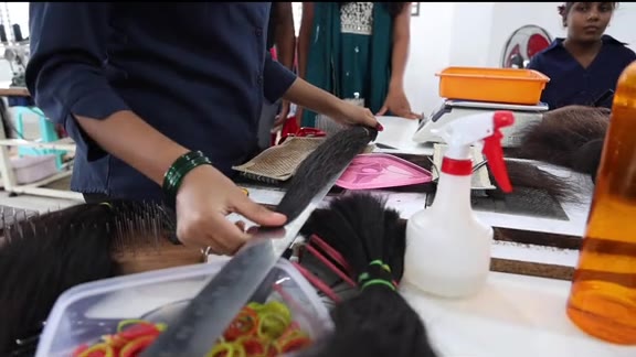 Sorting and trimming raw hair at the Chandra Hair factory