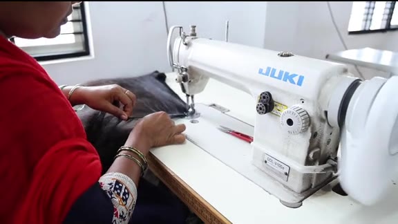 Machine wefting raw Indian hair at the Chandra Hair factory