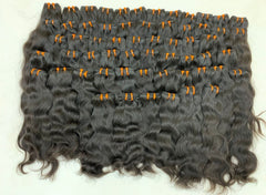 Natural wavy Cambodian raw hair weft bundles laid out, Chandra Hair